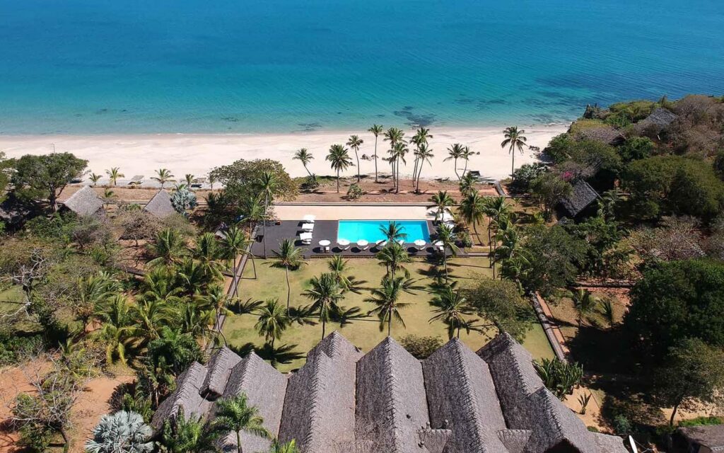 Aerial view of Anjajavy – Le Lodge, its pool and its palm-fringed beach, facing the lagoon