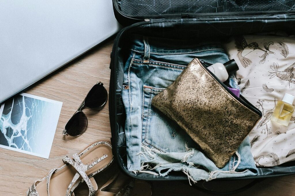 Passport, glasses and an open bag ready for departure