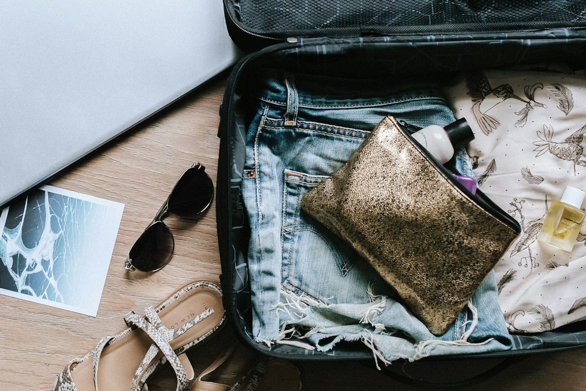 Passport, glasses and an open bag ready for departure