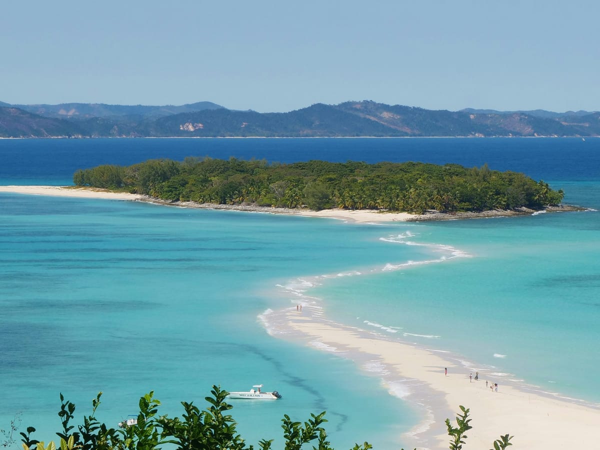 Looking down on the sandbar that winds through the turquoise lagoon to the wooded islet of Nosy Iranja.