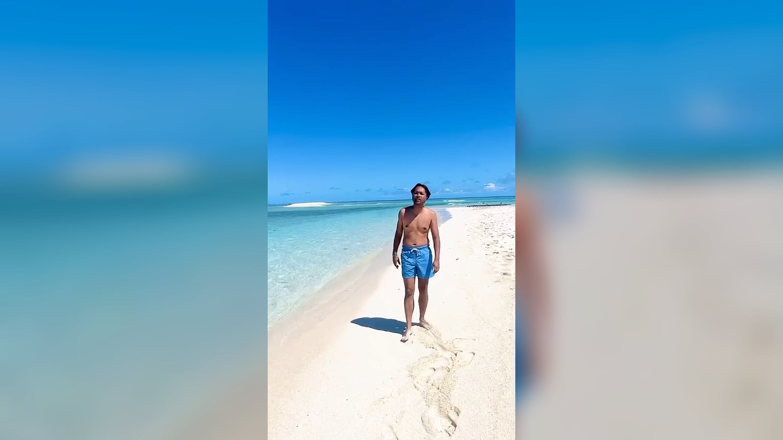 Our CEO on the white sandbank of Îlot Sables, facing the turquoise lagoon