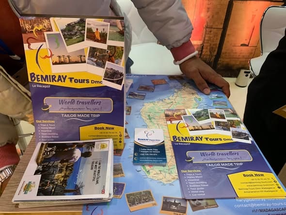Bemiray Tours brochures and a map of Madagascar on the stand's counter
